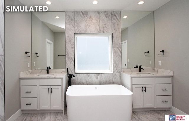 941 N 104th St, Lincoln, NE 68527 - full bath with marble finish flooring, recessed lighting, a soaking tub, and two vanities