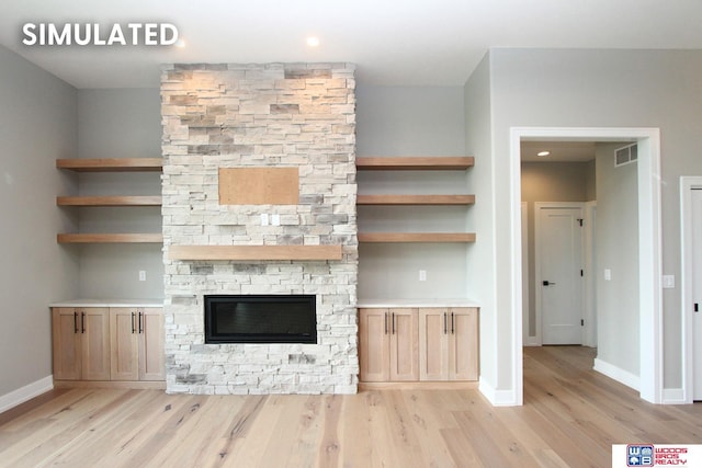 941 N 104th St, Lincoln, NE 68527 - unfurnished living room featuring light wood-style floors, a stone fireplace, stairway, and recessed lighting