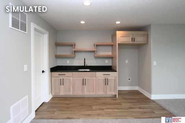 941 N 104th St, Lincoln, NE 68527 - kitchen with open shelves, light wood finished floors, dark countertops, recessed lighting, and light brown cabinetry