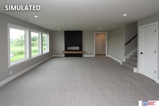 941 N 104th St, Lincoln, NE 68527 - unfurnished living room with recessed lighting, stairs, and carpet