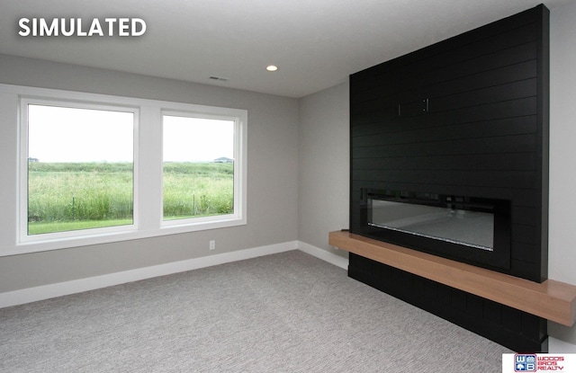 941 N 104th St, Lincoln, NE 68527 - unfurnished living room featuring a large fireplace, carpet floors, and recessed lighting
