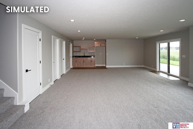 941 N 104th St, Lincoln, NE 68527 - unfurnished living room featuring recessed lighting and light colored carpet