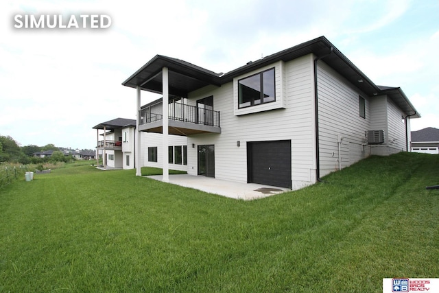 941 N 104th St, Lincoln, NE 68527 - rear view of house with a balcony, an attached garage, a patio area, and a lawn