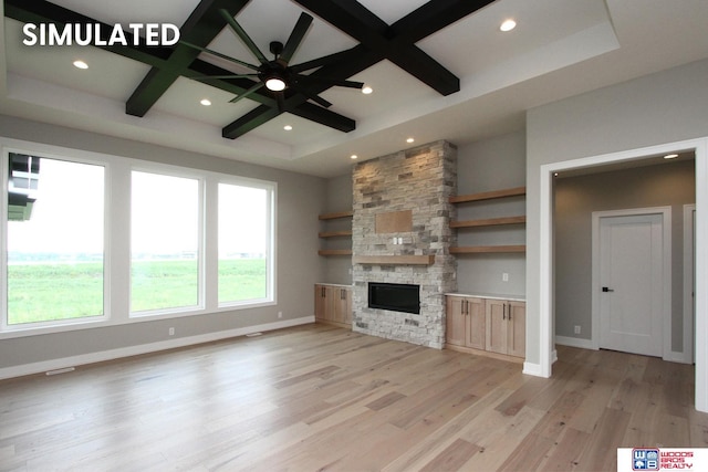 941 N 104th St, Lincoln, NE 68527 - unfurnished living room featuring coffered ceiling, recessed lighting, light wood-style floors, a stone fireplace, and beam ceiling