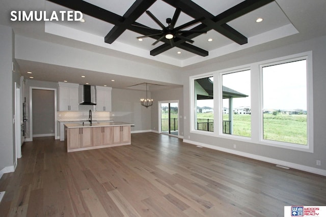 941 N 104th St, Lincoln, NE 68527 - kitchen featuring wall chimney exhaust hood, coffered ceiling, open floor plan, light countertops, and a chandelier