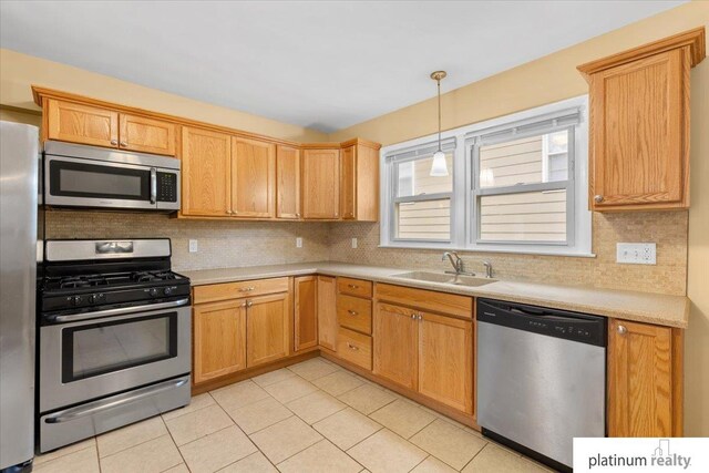 3052 S 46th Ave, Omaha, NE 68106 - kitchen featuring stainless steel appliances, light countertops, and tasteful backsplash