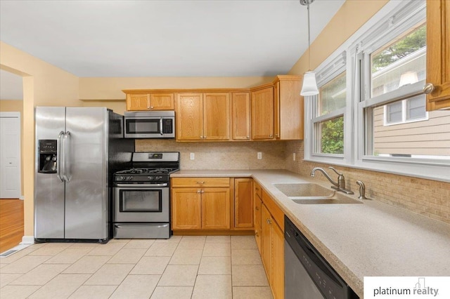 3052 S 46th Ave, Omaha, NE 68106 - kitchen with stainless steel appliances, plenty of natural light, backsplash, and light countertops