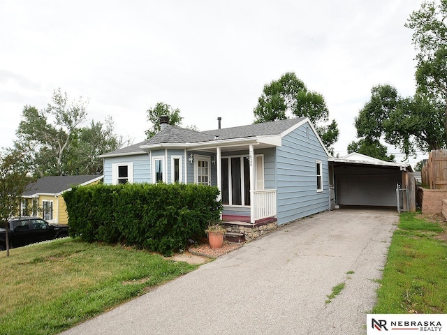 7626 S 41st St, Bellevue, NE 68147 - view of front facade featuring a chimney, a front lawn, and asphalt driveway