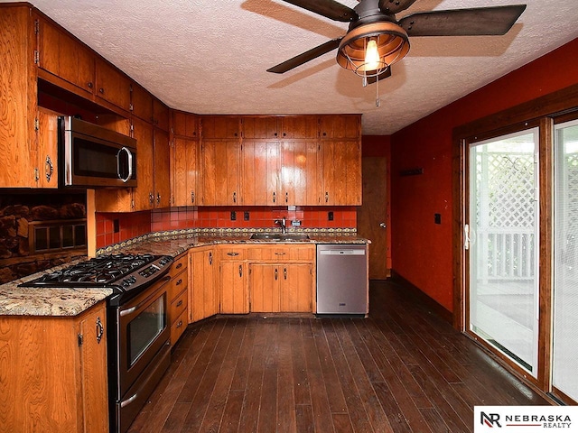 7626 S 41st St, Bellevue, NE 68147 - kitchen with stainless steel appliances, decorative backsplash, a textured ceiling, a ceiling fan, and dark wood finished floors