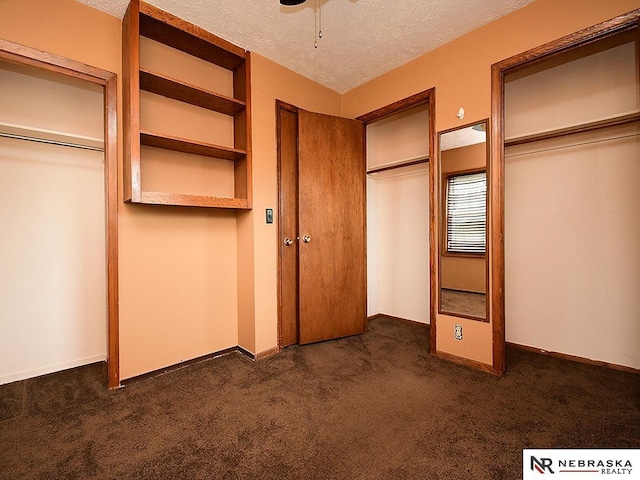 7626 S 41st St, Bellevue, NE 68147 - unfurnished bedroom featuring dark colored carpet and a textured ceiling
