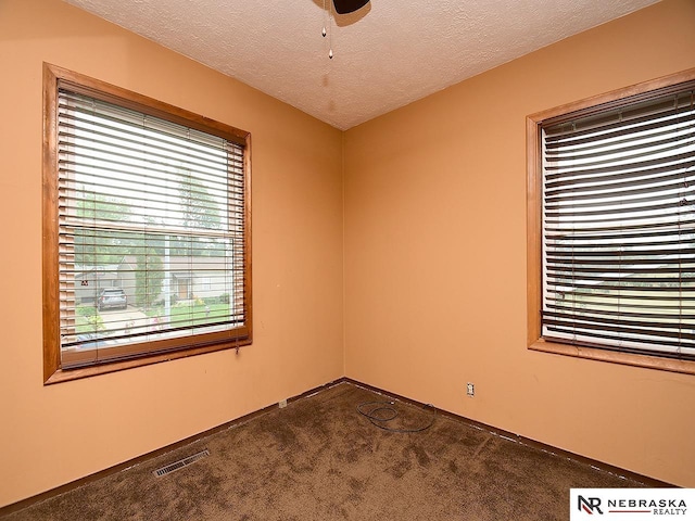 7626 S 41st St, Bellevue, NE 68147 - empty room featuring dark carpet, a textured ceiling, and a ceiling fan