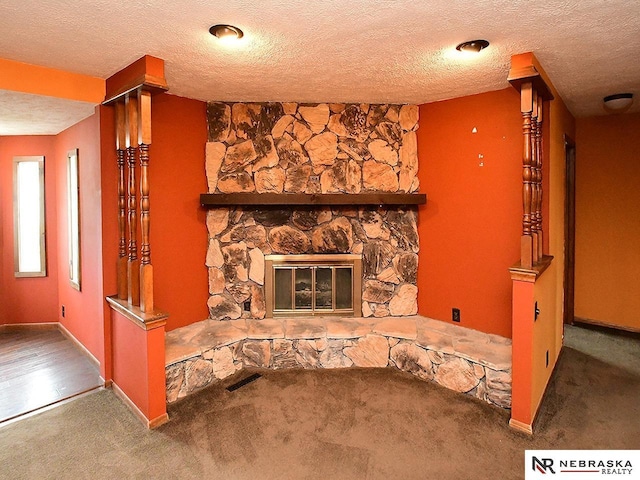 7626 S 41st St, Bellevue, NE 68147 - detailed view of carpet flooring, a stone fireplace, and a textured ceiling
