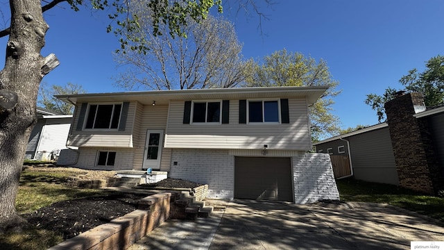 6361 S 140th Ave, Omaha, NE 68137 - bi-level home with an attached garage, brick siding, and concrete driveway