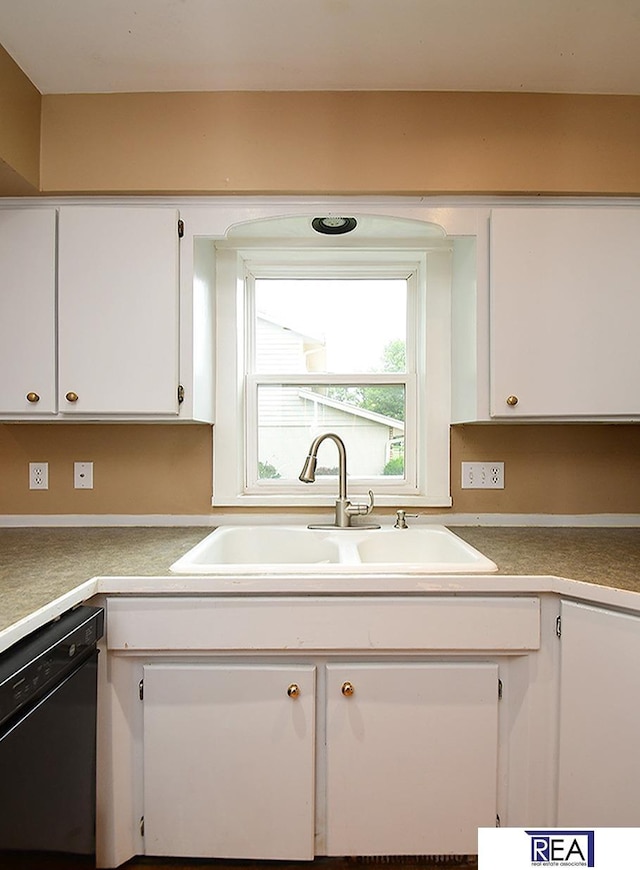 1312 N 148th Plz, Omaha, NE 68154 - kitchen with black dishwasher, white cabinets, and light countertops