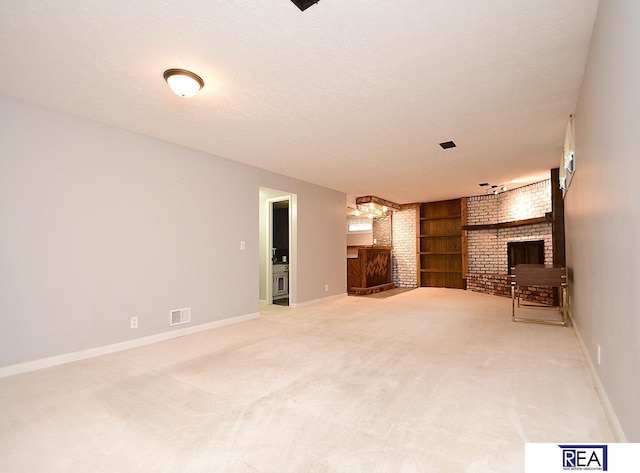1312 N 148th Plz, Omaha, NE 68154 - unfurnished living room featuring a fireplace, built in features, and carpet flooring