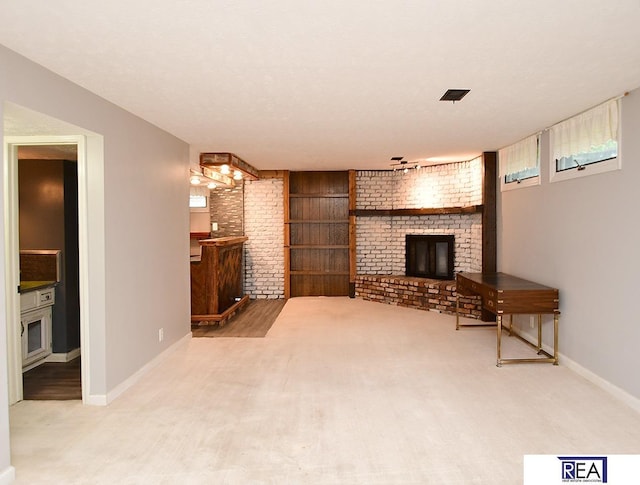 1312 N 148th Plz, Omaha, NE 68154 - unfurnished living room with a brick fireplace and carpet floors