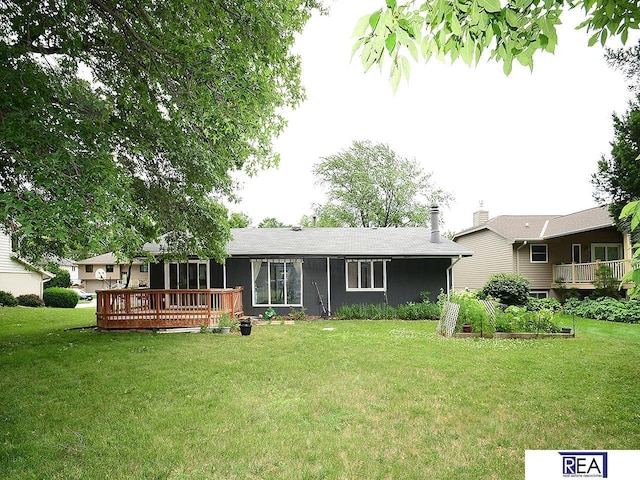 1312 N 148th Plz, Omaha, NE 68154 - view of front of house with a wooden deck, a front yard, a vegetable garden, and a chimney