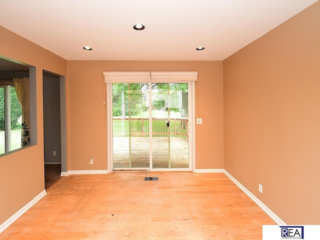 1312 N 148th Plz, Omaha, NE 68154 - empty room featuring plenty of natural light, light wood finished floors, and recessed lighting