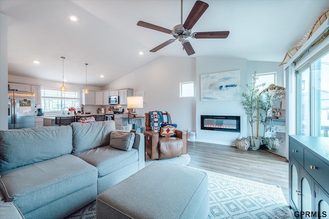 7794 N 88th St, Omaha, NE 68122 - living room with light wood-type flooring, lofted ceiling, ceiling fan, recessed lighting, and a glass covered fireplace