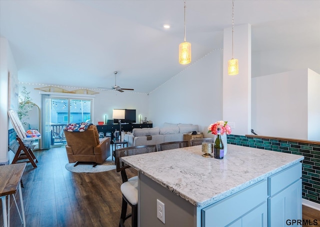 7794 N 88th St, Omaha, NE 68122 - kitchen featuring dark wood finished floors, lofted ceiling, ceiling fan, light stone counters, and pendant lighting