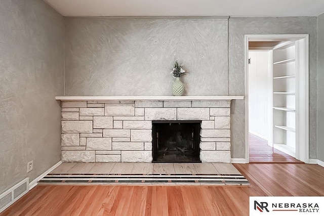 437 S 90th St, Omaha, NE 68114 - detailed view of wood finished floors, a stone fireplace, and built in features