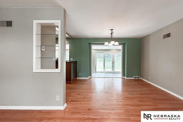 437 S 90th St, Omaha, NE 68114 - unfurnished dining area with a chandelier and light wood finished floors