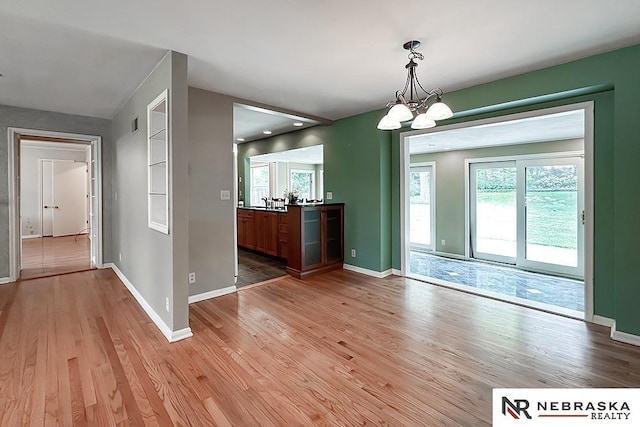 437 S 90th St, Omaha, NE 68114 - unfurnished dining area with light wood-style flooring and a chandelier