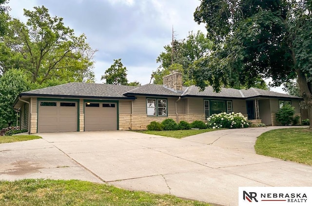 437 S 90th St, Omaha, NE 68114 - ranch-style house with concrete driveway, an attached garage, a chimney, stone siding, and a front yard