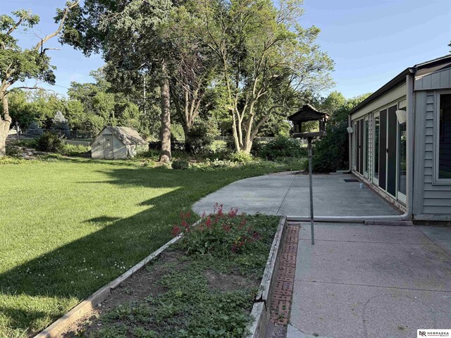 437 S 90th St, Omaha, NE 68114 - view of green lawn with a patio and a storage shed