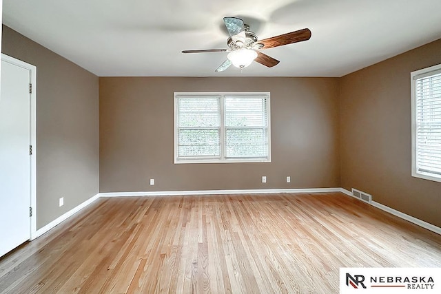 437 S 90th St, Omaha, NE 68114 - unfurnished room featuring ceiling fan, healthy amount of natural light, and light wood-style flooring
