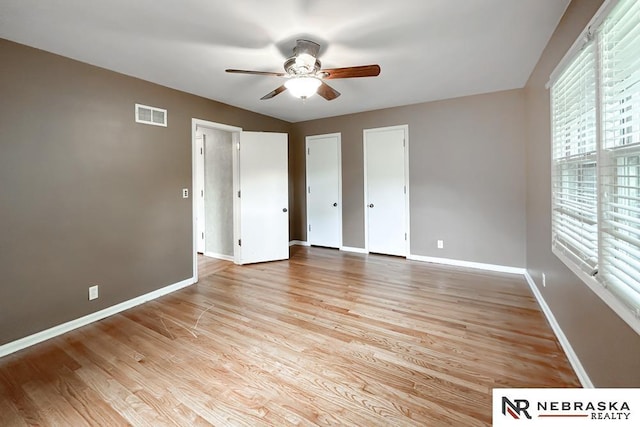 437 S 90th St, Omaha, NE 68114 - unfurnished bedroom featuring light wood-style floors, multiple closets, and a ceiling fan