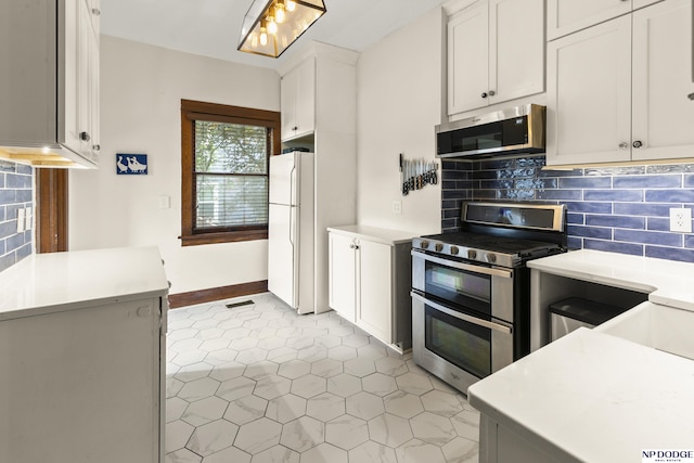 4340 Miami St, Omaha, NE 68104 - kitchen featuring stainless steel appliances, tasteful backsplash, light tile patterned flooring, light countertops, and white cabinets