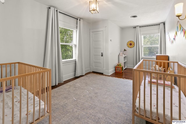 4340 Miami St, Omaha, NE 68104 - bedroom featuring multiple windows and wood finished floors