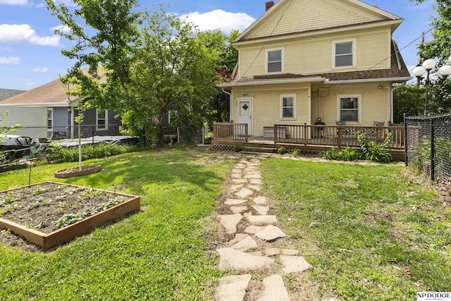 4340 Miami St, Omaha, NE 68104 - rear view of house featuring a garden, a fenced backyard, a deck, and a chimney