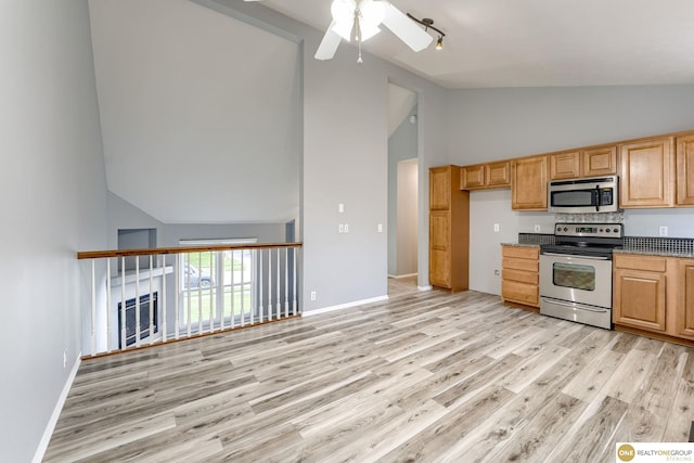 18653 Borman St, Omaha, NE 68135 - kitchen with stainless steel appliances, high vaulted ceiling, light wood-style flooring, ceiling fan, and dark countertops