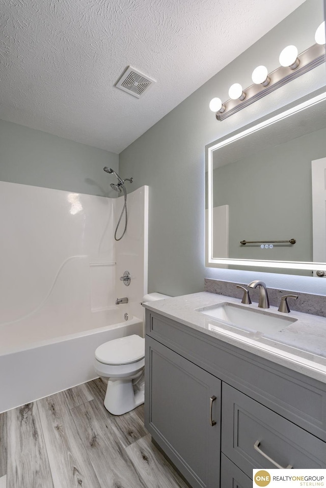 18653 Borman St, Omaha, NE 68135 - bathroom featuring vanity, wood finished floors, bathing tub / shower combination, and a textured ceiling