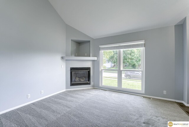 18653 Borman St, Omaha, NE 68135 - unfurnished living room with carpet, a glass covered fireplace, and vaulted ceiling