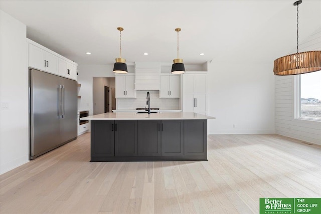 5721 N 197th Ave, Omaha, NE 68022 - kitchen with stainless steel built in fridge, light wood finished floors, light countertops, white cabinets, and recessed lighting