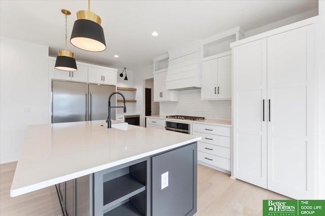 5721 N 197th Ave, Omaha, NE 68022 - kitchen with stainless steel appliances, custom range hood, tasteful backsplash, light wood finished floors, and open shelves