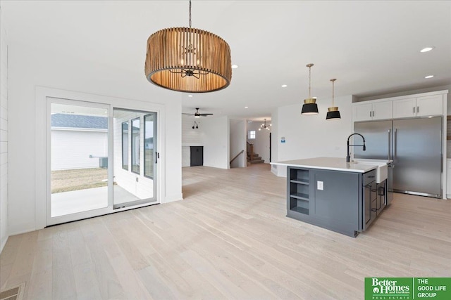 5721 N 197th Ave, Omaha, NE 68022 - kitchen featuring stainless steel built in refrigerator, a chandelier, light wood-style floors, light countertops, and hanging light fixtures