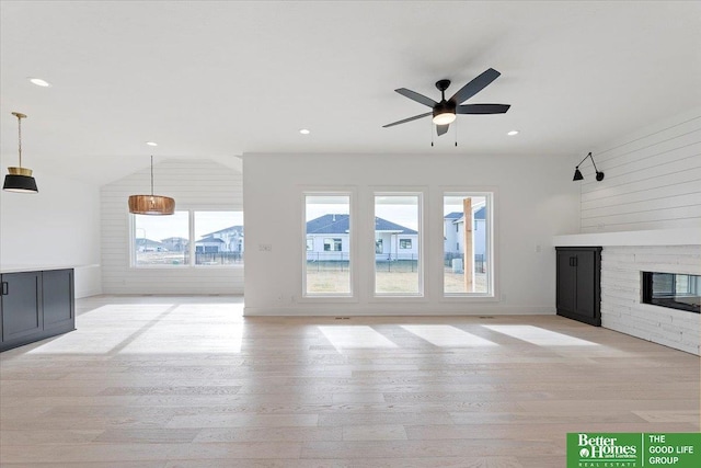 5721 N 197th Ave, Omaha, NE 68022 - unfurnished living room featuring plenty of natural light, a fireplace, a ceiling fan, light wood finished floors, and recessed lighting