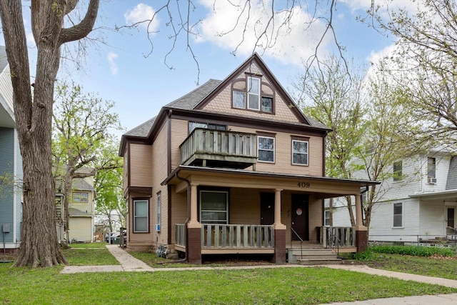 409 N 25th St, Lincoln, NE 68503 - view of front of house with a balcony, a porch, and a front lawn