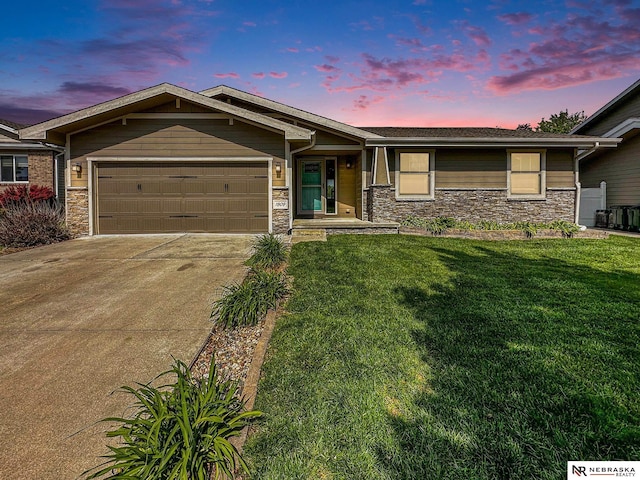 1809 SW Derek Ave, Lincoln, NE 68522 - view of front facade with stone siding, a garage, driveway, and a yard