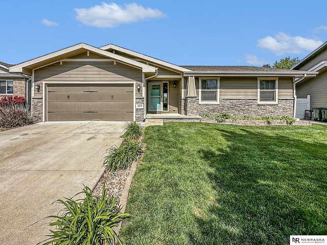 1809 SW Derek Ave, Lincoln, NE 68522 - view of front facade with stone siding, a garage, driveway, and a front yard