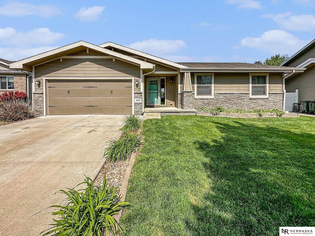 1809 SW Derek Ave, Lincoln, NE 68522 - view of front of home with stone siding, an attached garage, a front yard, and driveway