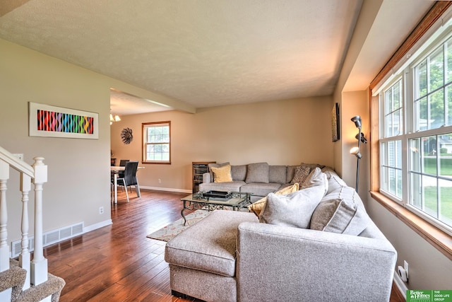 14824 Charles Plz, Omaha, NE 68154 - living room with dark wood-type flooring, stairs, and a chandelier