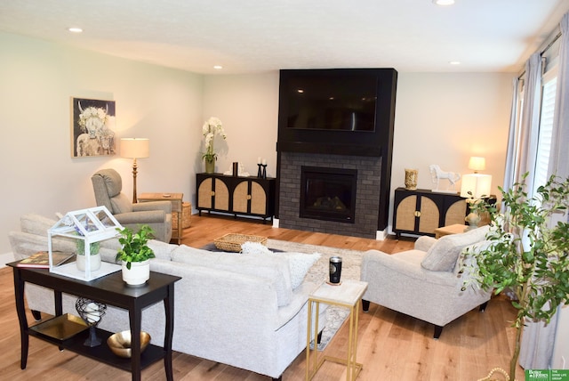 5445 Kestrel Pkwy, Omaha, NE 68022 - living room featuring wood finished floors, recessed lighting, and a brick fireplace