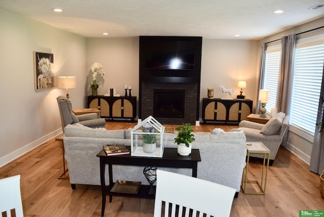 5445 Kestrel Pkwy, Omaha, NE 68022 - living room with light wood-style flooring, a brick fireplace, and recessed lighting