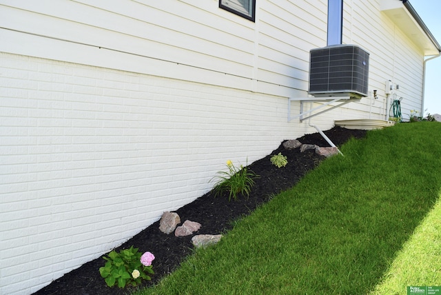 5445 Kestrel Pkwy, Omaha, NE 68022 - view of home's exterior featuring a cooling unit and a lawn
