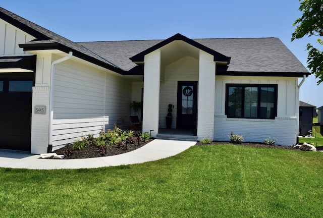 5445 Kestrel Pkwy, Omaha, NE 68022 - view of front of property featuring an attached garage, a shingled roof, brick siding, and board and batten siding